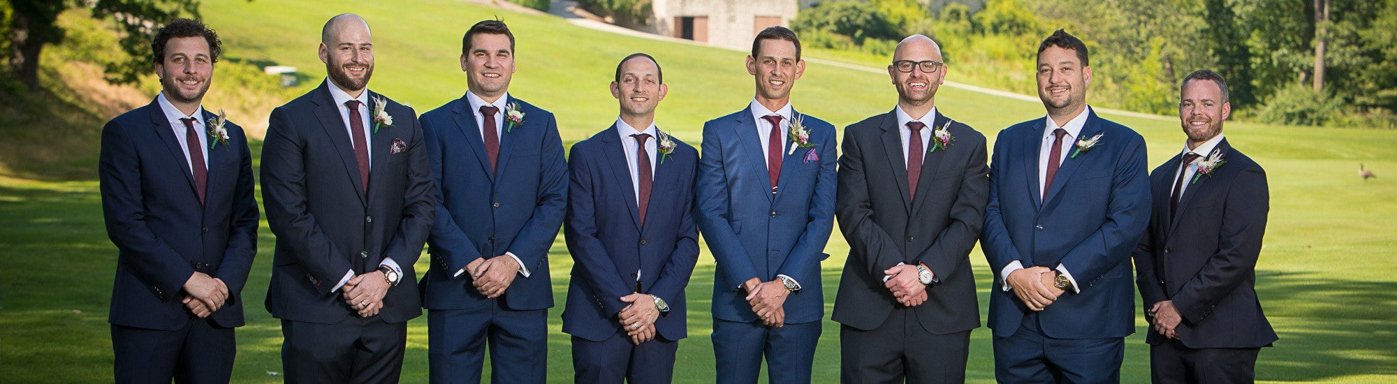 groomsmen wearing custom suits by j&a custom clothing at a wedding